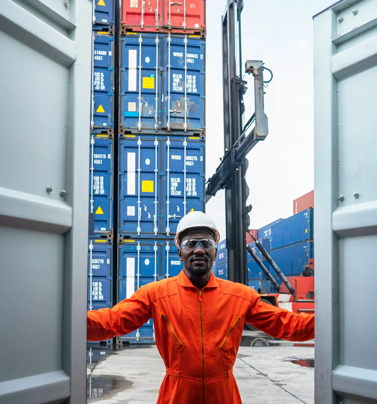 Jiva Consultings dock worker opening a shipping container at a freight yard