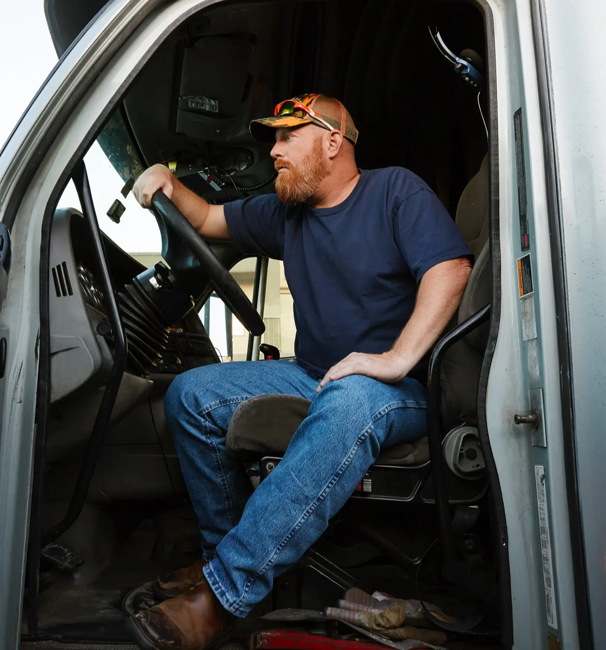 Truck driver sitting in the cab of his truck